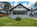 Charming single-story home featuring a screened-in front porch and freshly landscaped yard at 984 Cascade Sw Rd, Atlanta, GA 30311