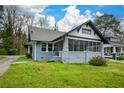 Inviting home with a screened porch and well-maintained lawn at 984 Cascade Sw Rd, Atlanta, GA 30311