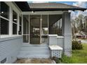Inviting screened-in front porch with classic brick columns and neutral paint at 984 Cascade Sw Rd, Atlanta, GA 30311