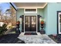 Elegant double front doors flanked by lights and planters create a welcoming entrance at 1206 Red Fox Cir, Woodstock, GA 30188