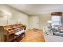 Comfortable living room featuring hardwood floors, a grand piano, neutral paint, and modern furnishings at 213 The South Chace Ne, Sandy Springs, GA 30328