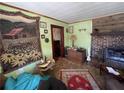 Cozy living room featuring a brick fireplace and tapestry on the wall at 3291 Peachtree St, Lithia Springs, GA 30122