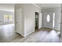 Bright entryway with neutral walls, light vinyl flooring, closet and half bathroom for convenience at 695 Park Place Way, Social Circle, GA 30025