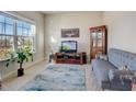 Cozy living room with a comfortable sofa, a decorative rug, and a large window at 104 Camilla Dr, Carrollton, GA 30116