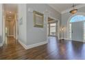 Grand foyer with hardwood floors, arched doorway, and elegant lighting creates a welcoming entrance at 8155 Legends View Ct, Cumming, GA 30028