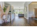 Elegant hallway with hardwood floors leading to a bright living area with large windows and natural light at 8155 Legends View Ct, Cumming, GA 30028