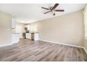 Open concept living space with updated flooring and a view into the adjacent kitchen and dining area at 869 Capitol View Nw Ave, Atlanta, GA 30318