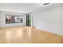 Spacious living room featuring hardwood floors and a large window with a balcony at 3481 Lakeside Ne Dr # 807, Atlanta, GA 30326