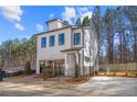 Modern two-story home with clean lines, a small yard, and private parking at 733 Stickley Oak Way, Woodstock, GA 30189