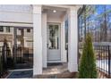 Inviting front entrance with a gray door, classic columns, and stylish black trim at 733 Stickley Oak Way, Woodstock, GA 30189
