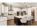 Modern kitchen featuring a large center island, white cabinets, and stainless steel appliances at 3560 Chattahoochee Rd, Cumming, GA 30041