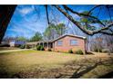 Charming brick home with a lush green lawn and covered porch at 6355 Valhalla Dr, Douglasville, GA 30135