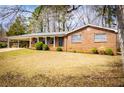 Front view of a red brick home with a covered front porch and driveway at 6355 Valhalla Dr, Douglasville, GA 30135