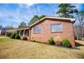 Side view of brick home featuring manicured landscaping at 6355 Valhalla Dr, Douglasville, GA 30135