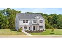 Classic two-story home boasts a lush green lawn and a white brick and vinyl facade at 640 Kimberwick Dr, Locust Grove, GA 30248
