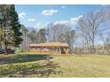 Spacious home with a large front yard, mature trees, and a classic brick facade at 9975 Holly Hill Way, Jonesboro, GA 30238