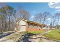 Brick home with an attached garage, long driveway, and well-kept lawn at 9975 Holly Hill Way, Jonesboro, GA 30238
