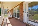Relaxing front porch features comfortable seating and a view of the surrounding landscape at 9975 Holly Hill Way, Jonesboro, GA 30238