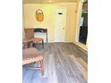 Inviting seating area with gray floors, patterned seating, a table, a mirror, and a white door at 2958 Klondike Rd, Lithonia, GA 30038