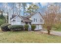 Inviting two-story home with light gray siding, a covered front porch, and mature landscaping at 6405 Grafton Dr, Austell, GA 30168