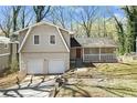 Charming home featuring a two-car garage, brick accents, and a welcoming front porch at 2339 Chevy Chase Ln, Decatur, GA 30032