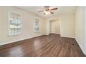 Bright living room with windows, ceiling fan, and gorgeous wood laminate flooring at 2339 Chevy Chase Ln, Decatur, GA 30032