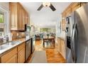 Well-lit kitchen showcasing wood cabinets, granite countertops, stainless steel appliances, and an open layout at 746 Amsterdam Ave, Atlanta, GA 30306