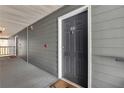 Exterior apartment entrance with gray siding, a dark-colored door, and visible unit number 8303 at 8303 Santa Fe Pkwy, Atlanta, GA 30350