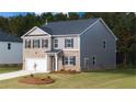 Beautiful two-story home with brick and siding, manicured lawn, and attached garage at 636 Kimberwick Dr, Locust Grove, GA 30248