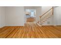 Open floor plan with hardwood floors leading to staircase and spacious kitchen at 3036 Lassiter Rd, Marietta, GA 30062