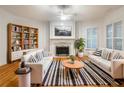 Bright living room with hardwood floors, fireplace, plantation shutters and stylish decor at 3036 Lassiter Rd, Marietta, GA 30062