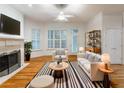 Inviting living room featuring hardwood floors, a fireplace, and plantation shutters at 3036 Lassiter Rd, Marietta, GA 30062