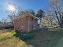 A two-story brick home with a spacious backyard, perfect for outdoor activities and enjoying nature at 239 Andrea Nw Cir, Lilburn, GA 30047