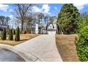 Wide view of a cozy home with an expansive driveway and manicured lawn at 290 Leigh Kay Dr, Lawrenceville, GA 30046
