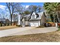 Suburban home with a driveway, two-car garage and well-maintained lawn at 290 Leigh Kay Dr, Lawrenceville, GA 30046