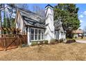 Home featuring white siding, manicured bushes and a wooden fence at 290 Leigh Kay Dr, Lawrenceville, GA 30046