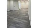 Inviting living room with gray wood-look floors, neutral walls, and natural light from large window at 596 Windchase Ln, Stone Mountain, GA 30083