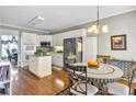 Eat-in kitchen features white cabinets, stainless appliances, and hardwood flooring at 1490 Highland Lake Dr, Lawrenceville, GA 30045