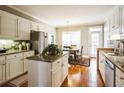 Charming kitchen with white cabinets, granite countertops, stainless appliances, and hardwood flooring at 1490 Highland Lake Dr, Lawrenceville, GA 30045