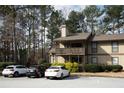 Exterior of tan home with a small balcony and parking spots available at 401 Woodcliff Dr, Atlanta, GA 30350