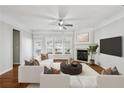 Comfortable living room with white sofas, hardwood floors, fireplace, and a large windows at 4718 Wehunt Se Trl # 20, Smyrna, GA 30082