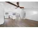 Spacious living area features hardwood floors, beamed ceilings, and staircase access to the upper level at 6730 Alvan Ct, Riverdale, GA 30296