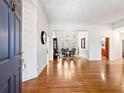 Elegant foyer with hardwood floors, high ceilings, and view of the formal dining room at 1544 Blue Bird Way, Cumming, GA 30041