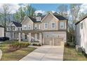 Beautiful two-story home with a two-car garage, a covered porch, and large windows at 278 Tillman Pass, Woodstock, GA 30188