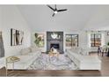 Bright living room featuring vaulted ceilings, fireplace, and large windows at 4843 Caboose Nw Ln, Acworth, GA 30102