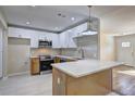 Modern kitchen featuring stainless steel appliances, a spacious island, and stylish two-tone cabinetry at 810 Commodore Nw Dr, Atlanta, GA 30318