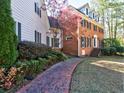 A charming brick home with black shutters and lush landscaping, creating an inviting curb appeal at 3012 Asheton Ne Pl, Marietta, GA 30068