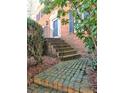 A welcoming front entrance features brick steps, an iron railing, and a freshly painted front door at 3012 Asheton Ne Pl, Marietta, GA 30068