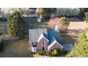 Aerial view of a well-maintained two-story home showcasing its roof, landscaping, and surrounding greenery at 3152 Parks Run, Loganville, GA 30052