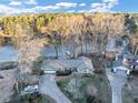 Aerial view of a home near a lake, surrounded by trees, showcasing its serene location at 4258 Rocky Ledge Way, Snellville, GA 30039